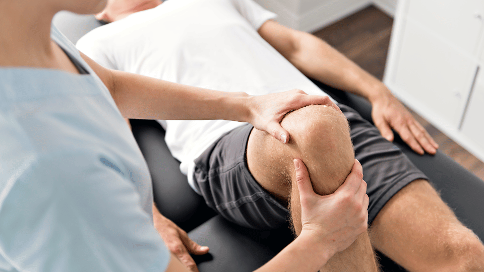 A Myotherapist in Melbourne assessing a patients knee